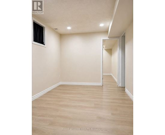 A room with a wooden floor and white walls.