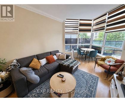 A living room with a grey couch and a coffee table.