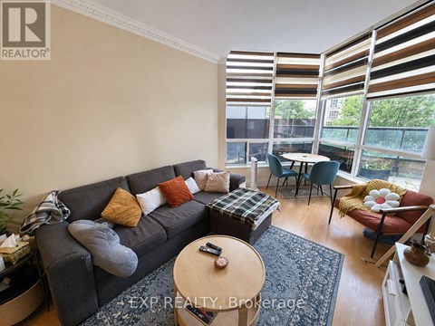 A living room with a grey couch and a coffee table.