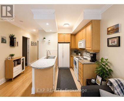 A kitchen with wooden cabinets and a white countertop.