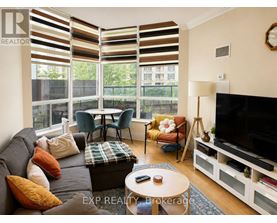 A living room with a grey couch, a coffee table, and a television.