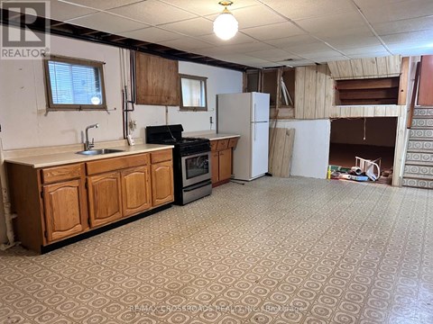 A kitchen with wooden cabinets and a patterned floor.