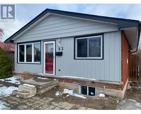 A grey house with a red door and a number 62 on it.