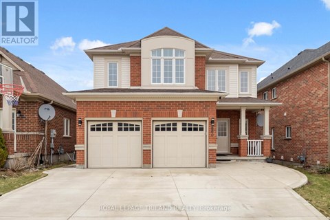 A large, two-story house with a garage is for sale.