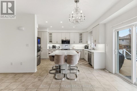 A modern kitchen with a dining table and chairs.