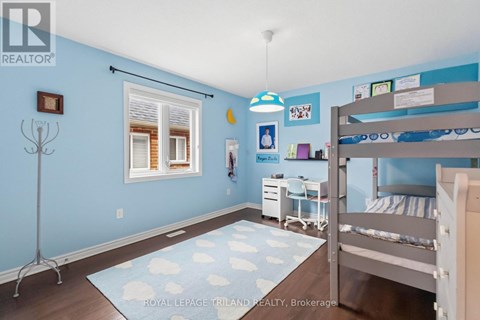 A bedroom with a bunk bed and a desk.