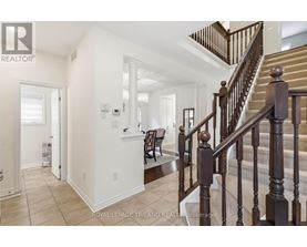 A staircase with a wooden banister leads to a second floor.