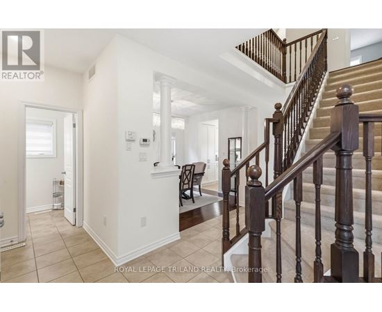 A staircase with a wooden banister leads to a second floor.