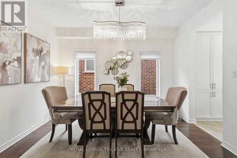 A dining room with a table set for four.