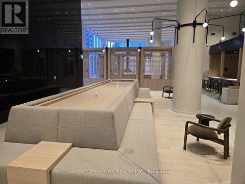 A modern office space with a long couch and a wooden table.