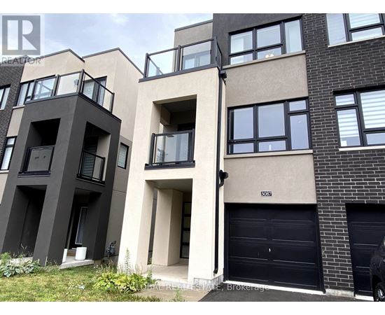 A modern apartment building with balconies and garage doors.
