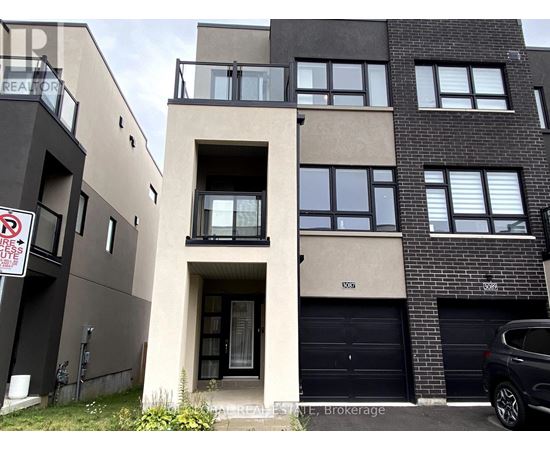 A modern apartment building with a car parked in front.