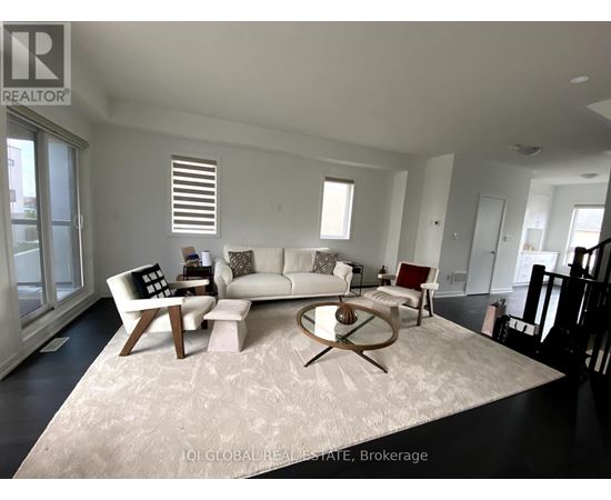 A living room with a white couch and a coffee table.