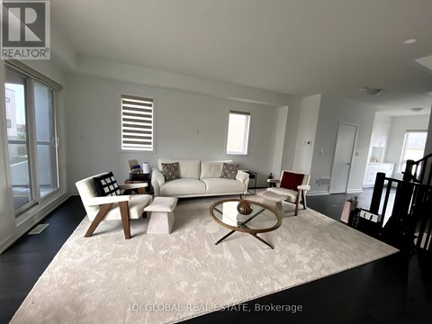 A living room with a white couch and a coffee table.