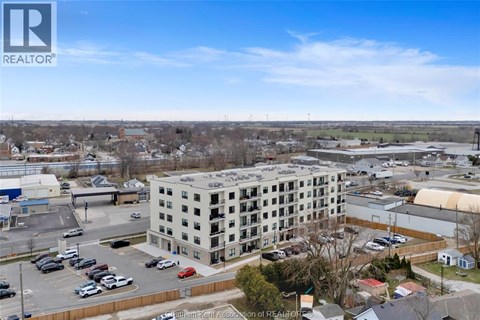 A large building with a parking lot in front of it.