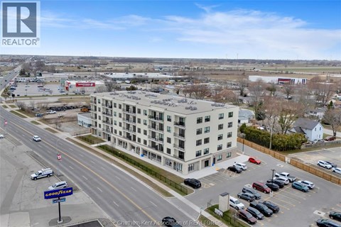 A large building with a parking lot in front of it.