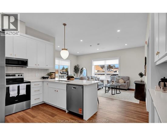 A modern kitchen with white cabinets and a large island.