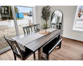 A dining room with a wooden table and chairs.