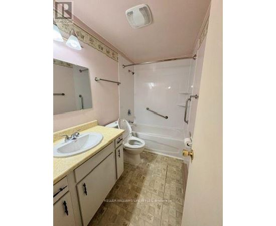 A bathroom with a sink, toilet, and shower.