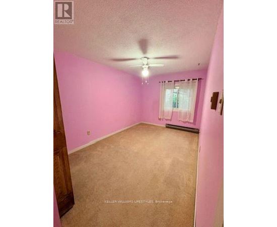 A room with pink walls and a window with white curtains.