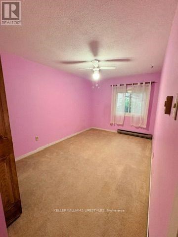 A room with pink walls and a window with white curtains.