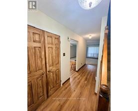 A room with wooden floors and a large wooden door.