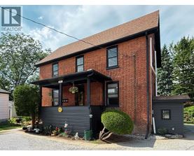 A red brick house with a black front.