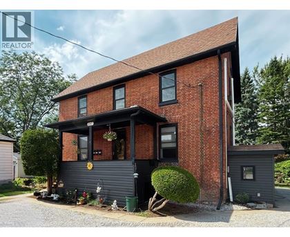 A red brick house with a black front.