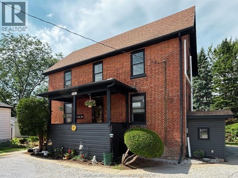 A red brick house with a black front.