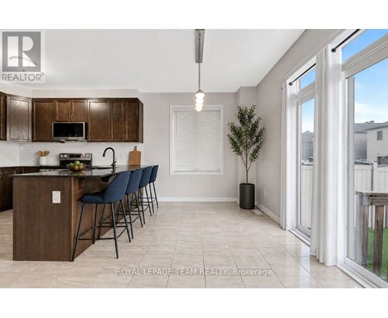 A kitchen with a dining table and chairs.