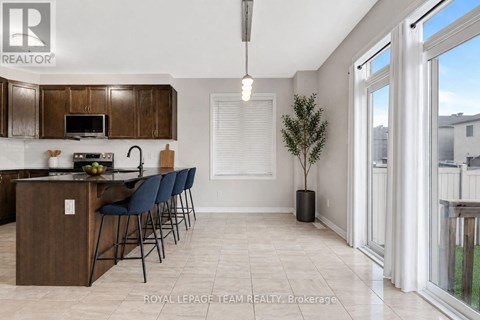 A kitchen with a dining table and chairs.