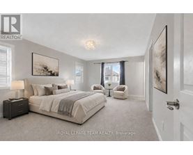 A bedroom with a large bed and a chair.