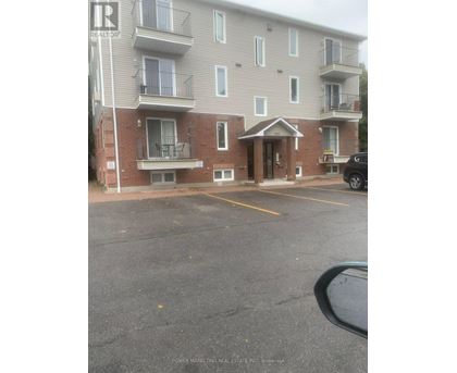 A building with a parking lot in front of it.