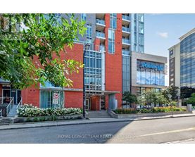 A building with a red and white facade is shown with the words "Royal LePage Team Realty Brokerage" on the bottom.