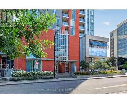 A building with a red and white facade is shown with the words "Royal LePage Team Realty Brokerage" on the bottom.