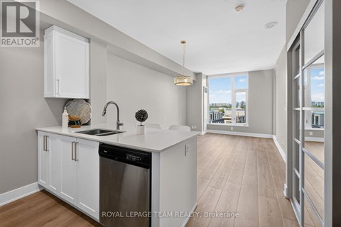A modern kitchen with white cabinets and a stainless steel dishwasher.