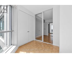 A bedroom with a sliding door and a mirror.