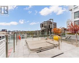 A rooftop with a pool table and chairs.