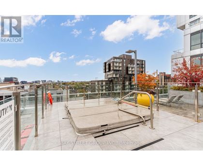 A rooftop with a pool table and chairs.