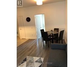 A dining room with a table set for four.