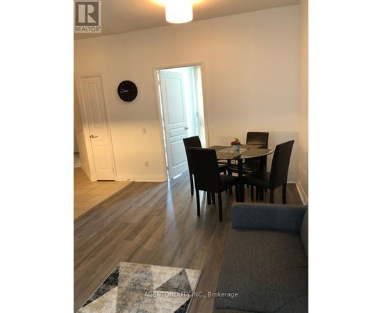 A dining room with a table set for four.