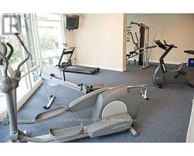 A gym with exercise equipment including a stationary bike and a treadmill.