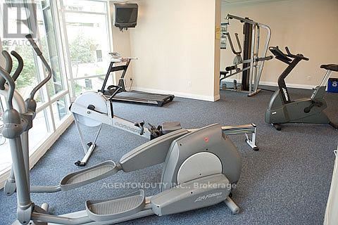 A gym with exercise equipment including a stationary bike and a treadmill.