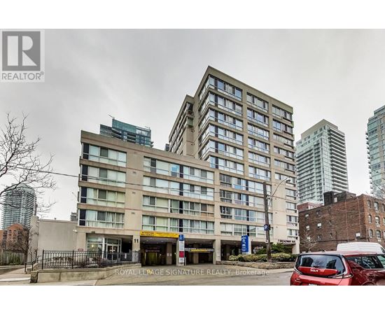 A large building with a Royal LePage Signature Realty Brokerage sign in front.