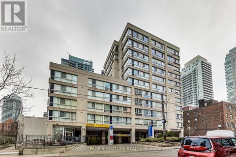 A large building with a Royal LePage Signature Realty Brokerage sign in front.