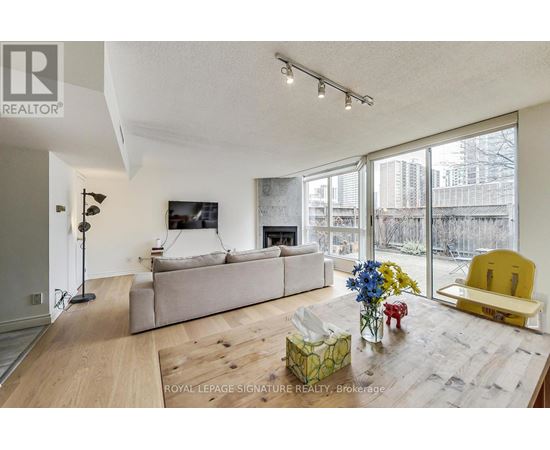 A living room with a white couch and a yellow chair.
