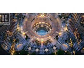 A modern building with a circular atrium and a pool in the middle.
