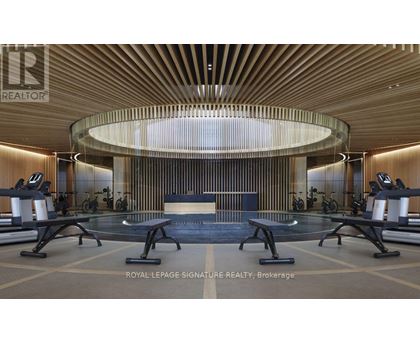 A gym with a circular mirror and wooden walls.