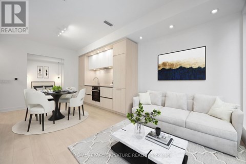 A modern living room with a dining table and chairs.