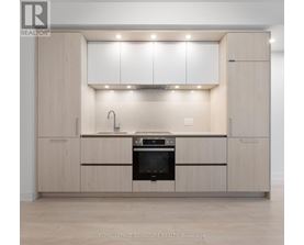 A modern kitchen with wooden cabinets and stainless steel appliances.